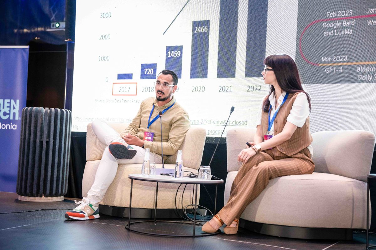 Silvija Gelevski moderating a tech conference panel on AI.