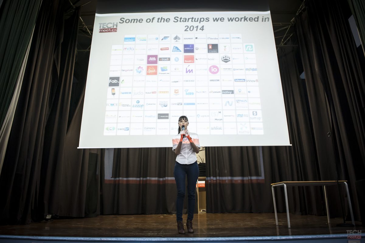 Silvija Gelevski speaking on stage at a startup meetup.